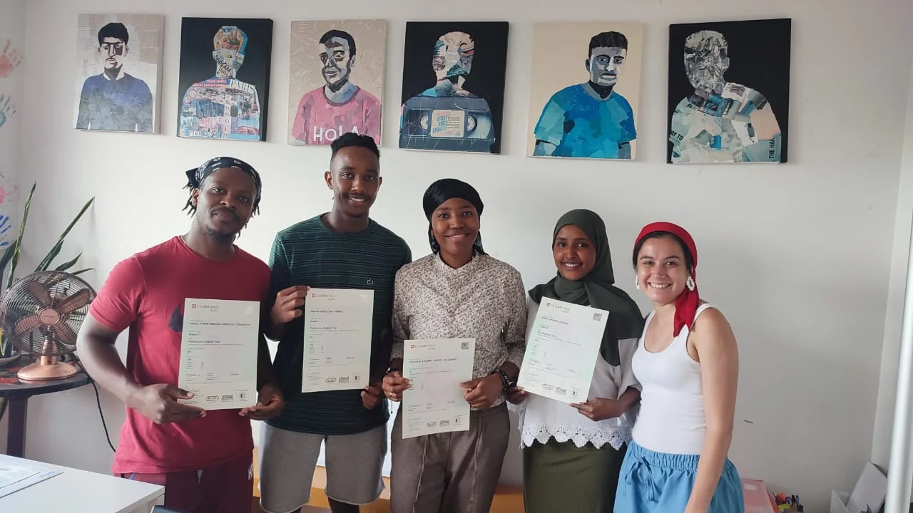 students holding up their English certificates